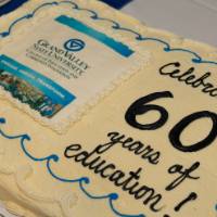 sheet cake that says "celebrating 60 years of education!"